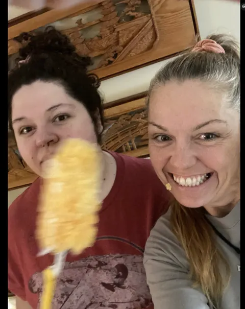 Two crew members with a yellow duster