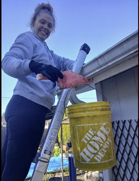 Nancy Davis smiling on a ladder